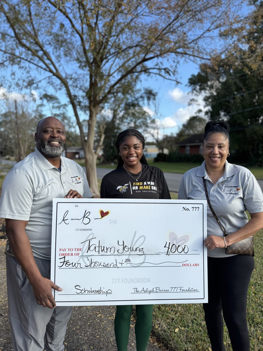 Scholarship recipient Tatum Young receiving $4,000 check from the Aaliyah Burras 777 Foundation